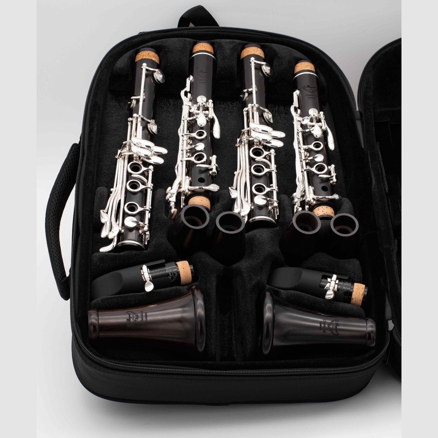 Pair of Royal Global Classical Limited Bb and A clarinets, laying disassembled in the case, with the case open to show the layout of the instrument parts inside