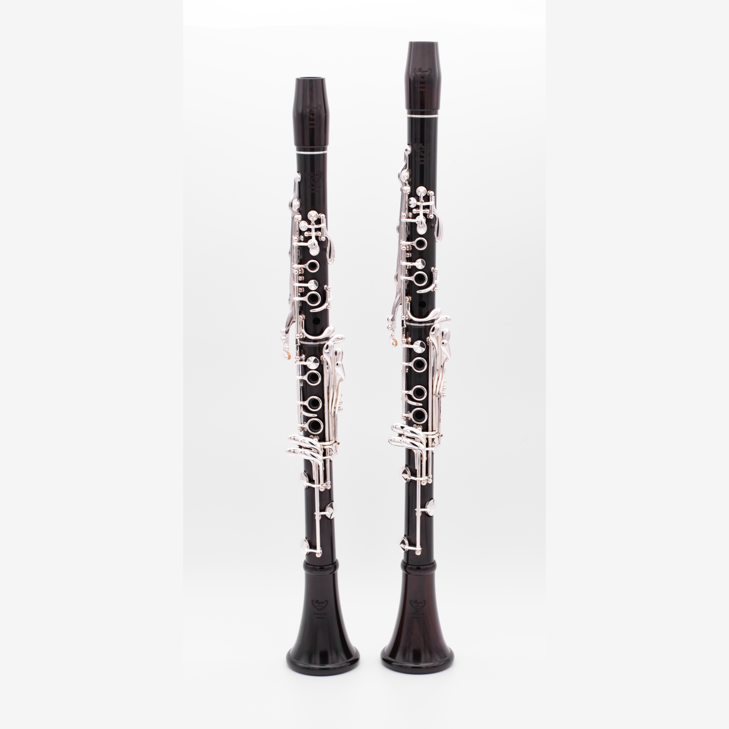 Pair of Royal Global Classical Limited Bb and A clarinets against a light gray background