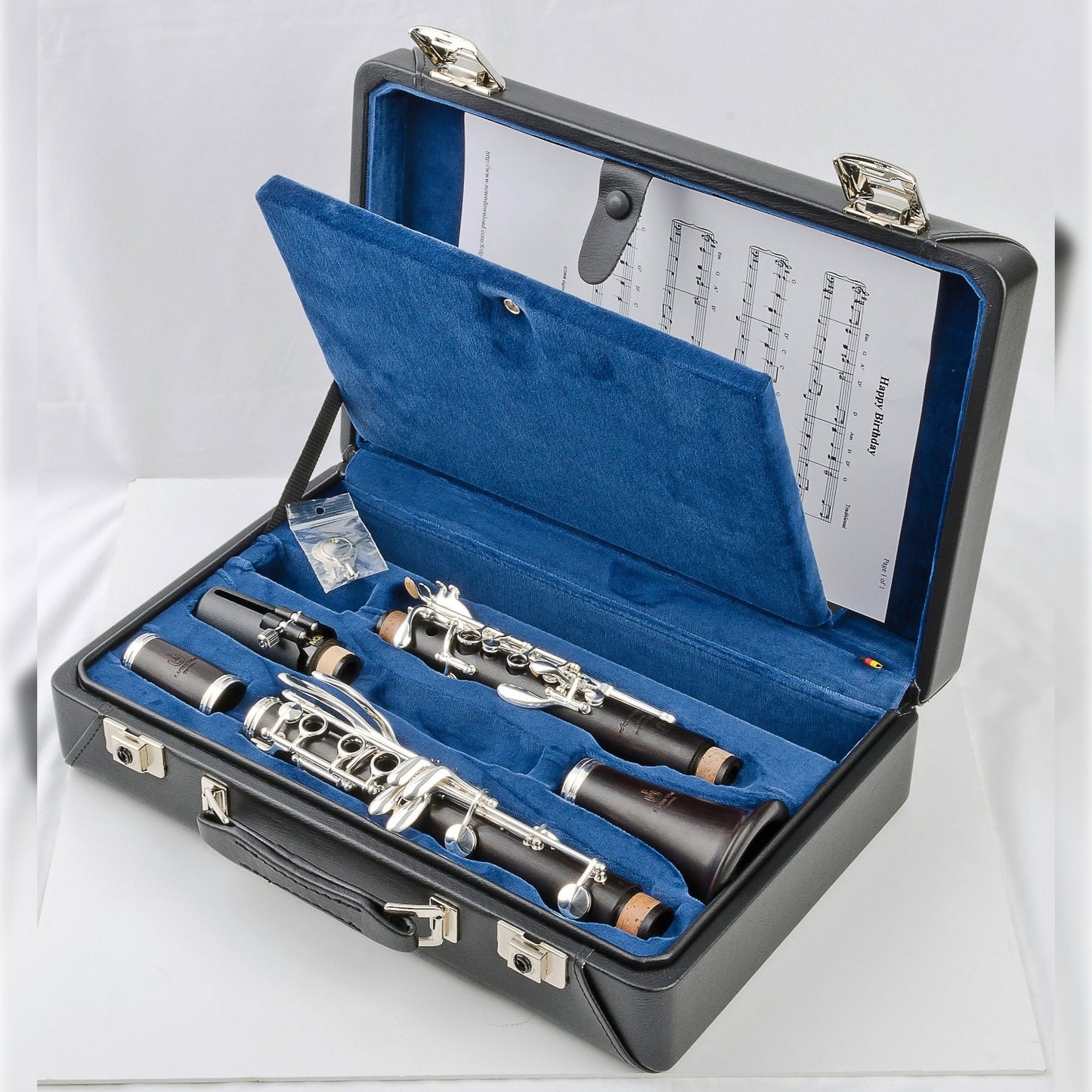 Uebel Advantage-L clarinet laying in its blue-lined case, open to show the sheet music compartment in the lid. 