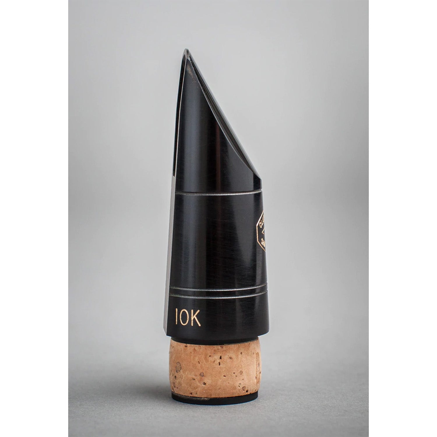 Side view of black Fobes 10k Bb mouthpiece on a gray background