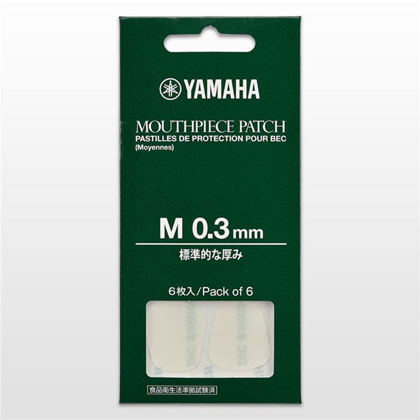 closed package of Yamaha clear mouthpiece patches, in green cardboard packaging, against white background